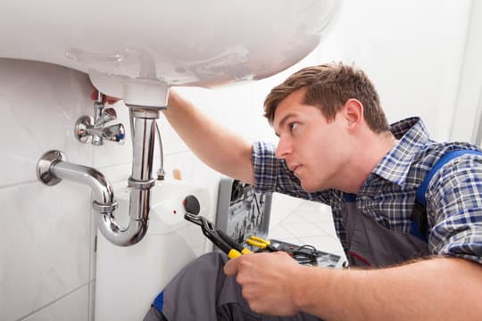 Professional plumber at work